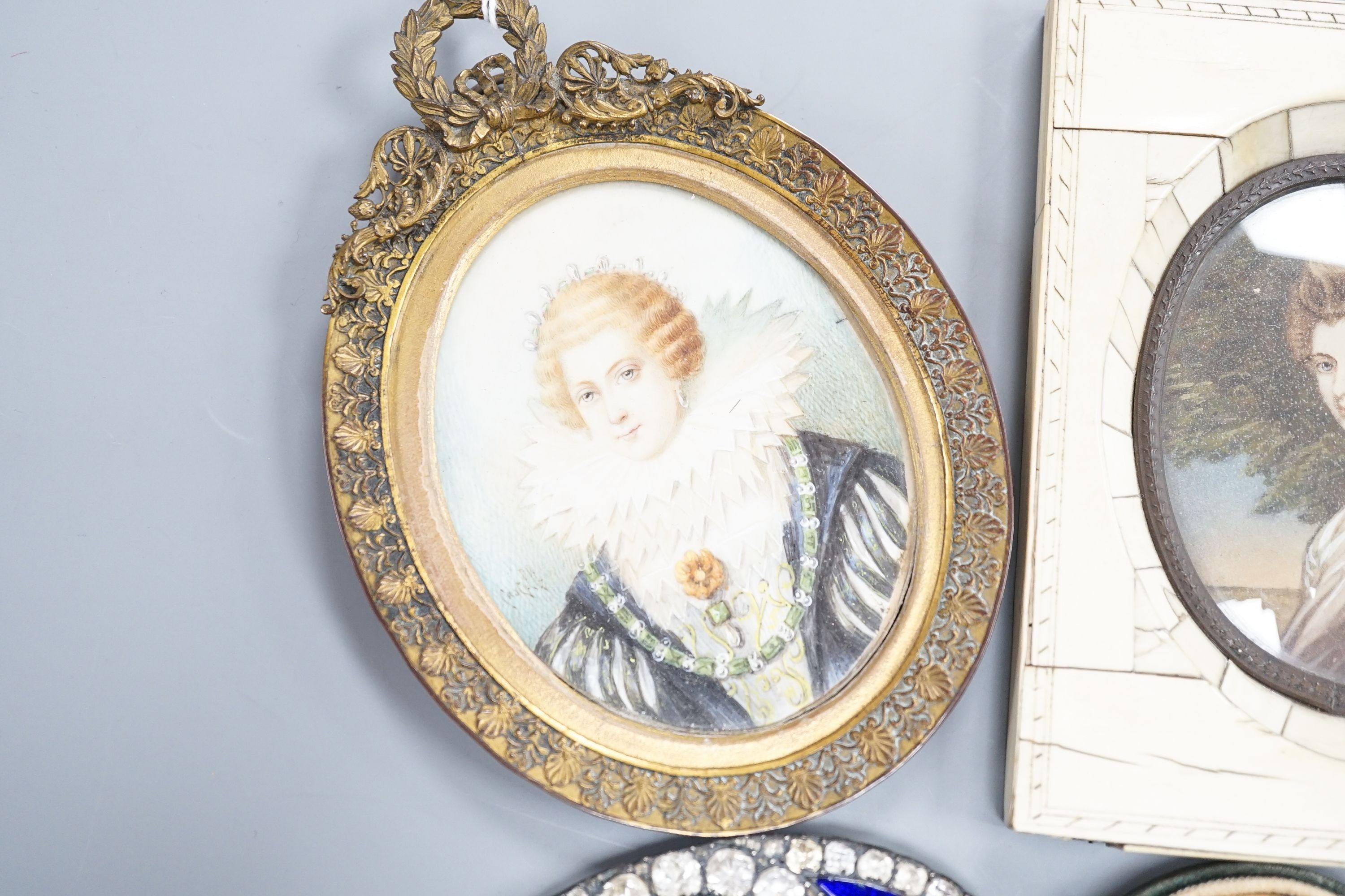 A paste and enamel framed Portrait miniature on ivory, 9.2cm and four other portrait miniatures (three on ivory)